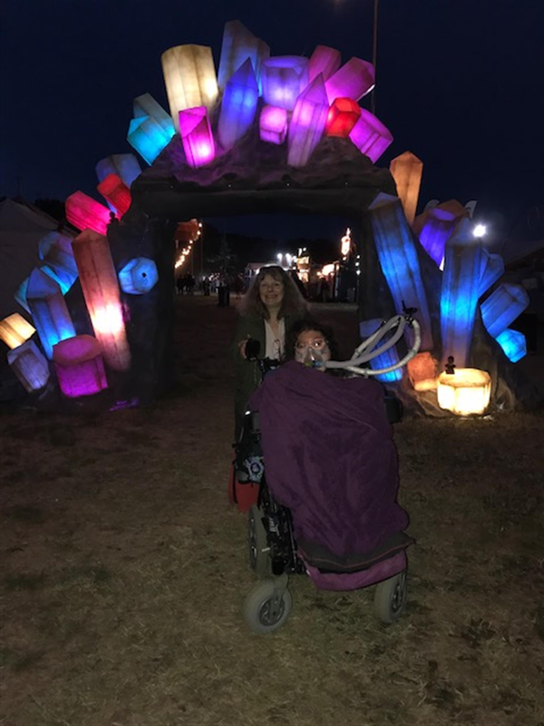 Image of two people in front of lights shaped like crystals