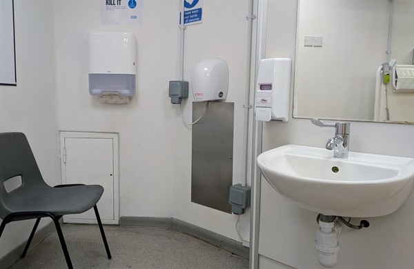 Image of sink, soap dispenser, hand dryer and paper towel dispenser