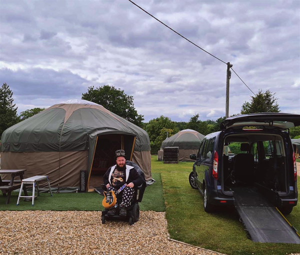 Image of a person in a wheelchair at a campsite
