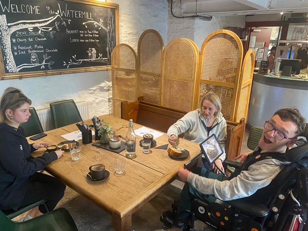 Image of three people in a cafe