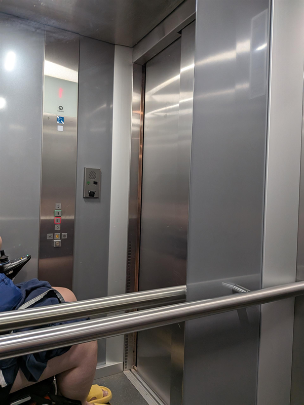 image of mirror and handrail inside lift