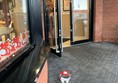 Image of entrance into the restaurant. One door is wide open
