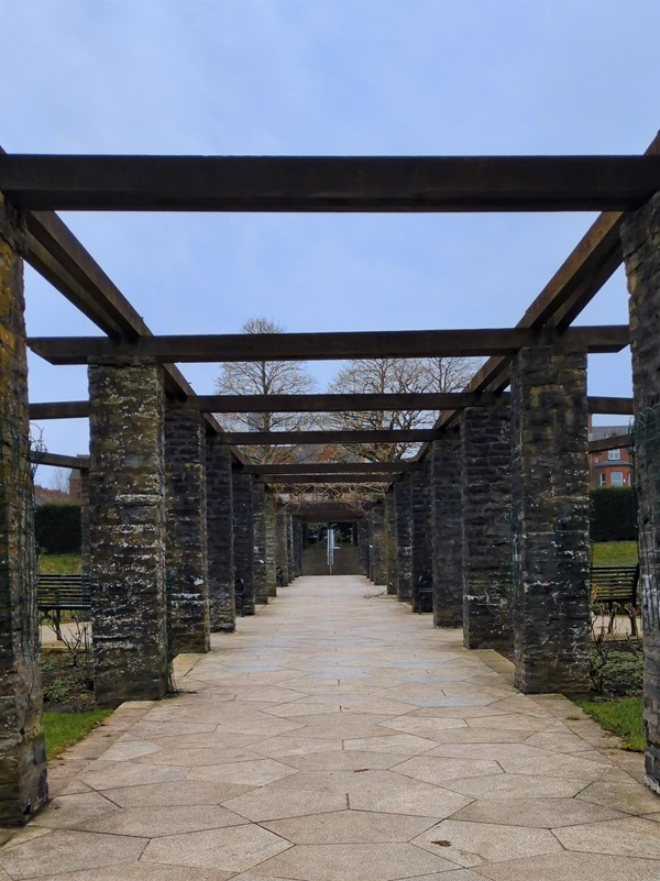 Image of wood and stone archways bordered by benches