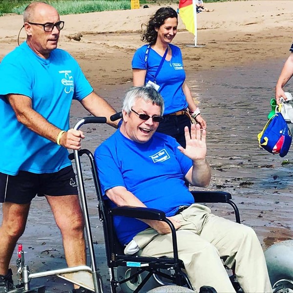 Reviewer trying out a beach wheelchair