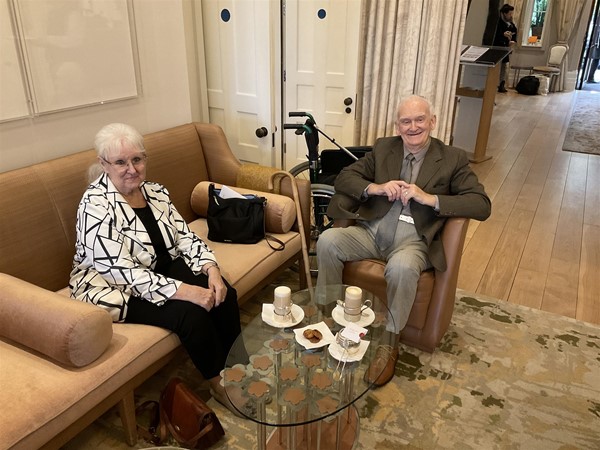 Image of two people sitting dwn