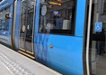 Image of tram at the tram stop, there's tactile paving at the edge