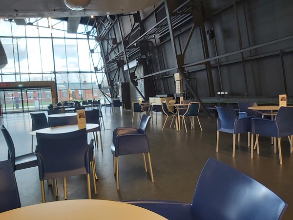 Free standing tables and chairs with arms and back support next to the Sutherland