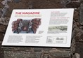 Information board about the Magazine, which is down some steps.