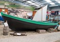 Fishing boat with a rough surfaced path next to it.