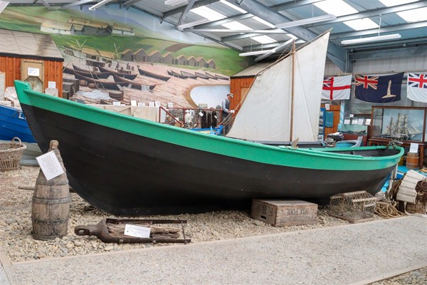 Fishing boat with a rough surfaced path next to it.