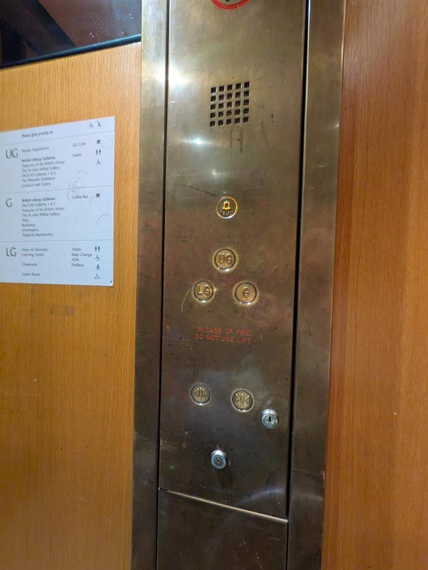 Image of lift access buttons. The lift buttons have braille markings