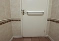 Image of a grabrail on a toilet door