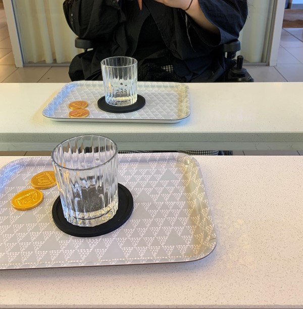 Image of the shelf at the mirrors with a tray of chocolates glass of water