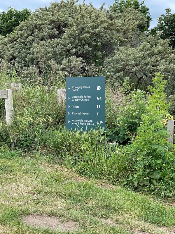 The sign in the car park indicating the direction for the Changing Places Toilet