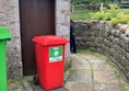 Wheelie bins on path to toilet