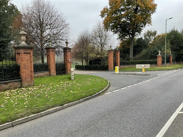 Image of a road and some red brick columns