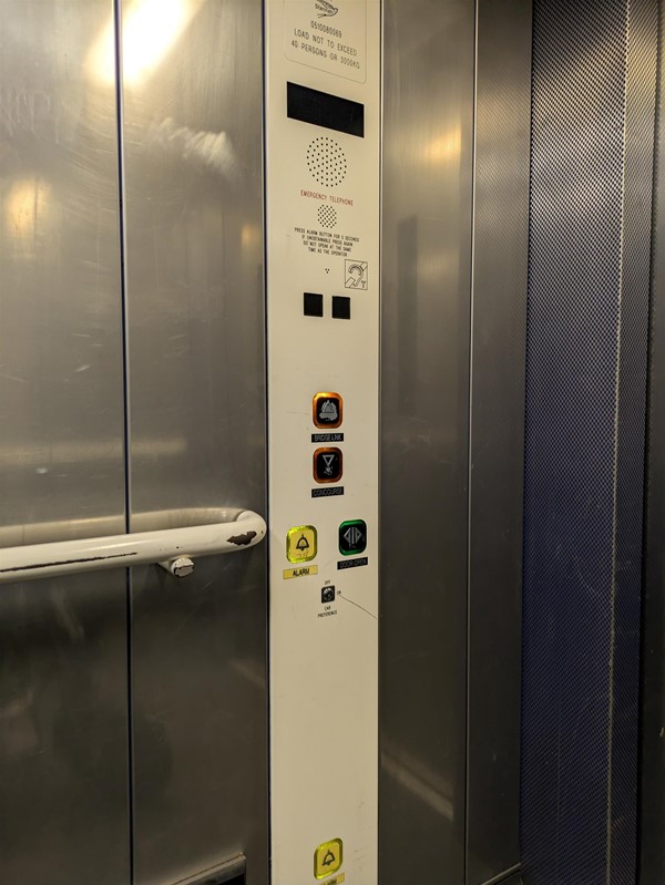 Image of lift access. The lift buttons have braille markings