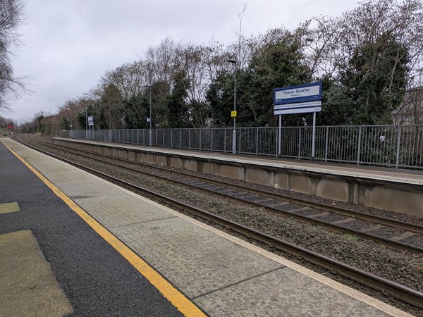 Image of the vacant platform, showing signage and tactile paving at the edge.