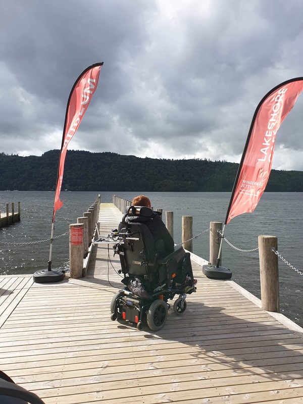 View of powerchair user on Jetty overlooking the lake