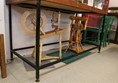 Spinning wheel with display case above.