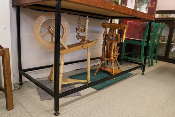 Spinning wheel with display case above.