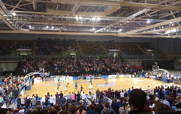 Basketball players on court during the game.