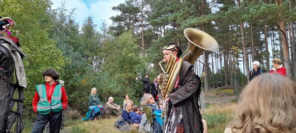 Picture of someone playing a trombone in a field