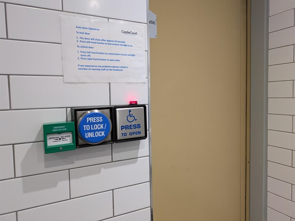 Image of control buttons for door at the accessible toilet