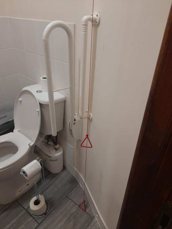 Accessible toilet with red cord