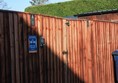 Gated bins area with locks at the top of the 2m high gates.