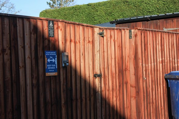 Gated bins area with locks at the top of the 2m high gates.