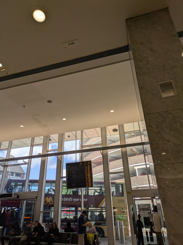 Image of bus gate with a bus on the other side of the window