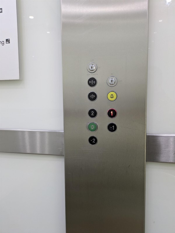 Image of lift buttons. The lift buttons do not have Braille Markings