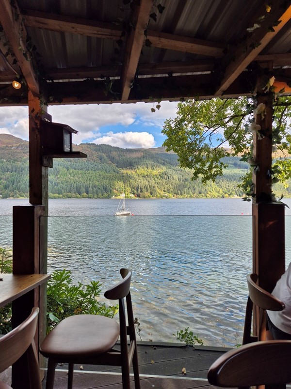 Image of a seating area by a loch