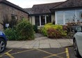Lowered kerb flush with tarmac with access to ramp on the right.