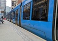 Image of tram at the tram stop, there's tactile paving at the edge
