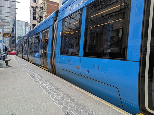Image of tram at the tram stop, there's tactile paving at the edge
