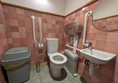 Image of accessible toilet - there is a bin in the transfer space