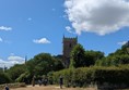 Image of of a path within the park witha tall tower in background