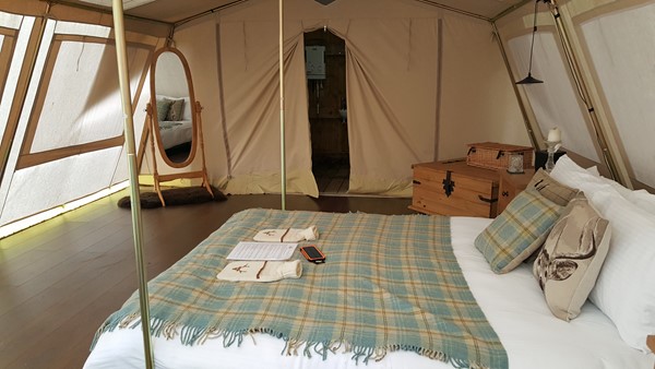 Accessible tent with king size bed, lots of floor space and en-suite bathroom.