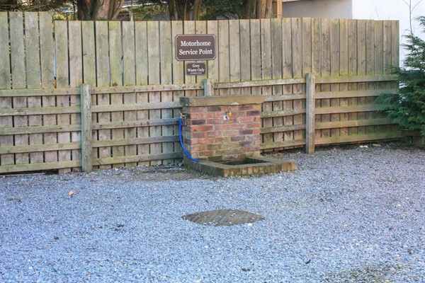 The motorhome service point with tap (which isn't working) and a drive over grey waste drain with large metal cover, which you have to lift off before using.