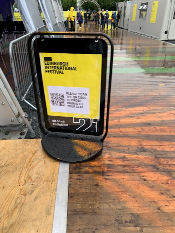 Sign saying scan QR code to order drinks from your seat