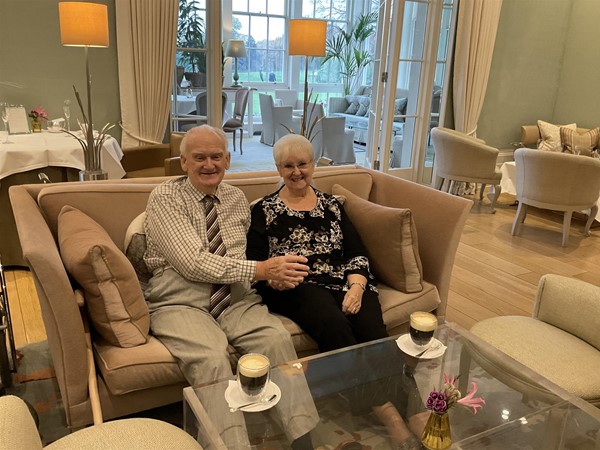 Image of two people seated