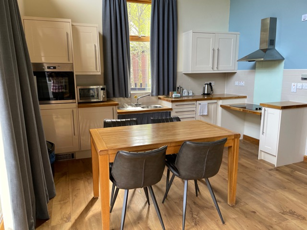 Interior of a Forest Holidays, Strathyre.  Dining table and Kitchen area