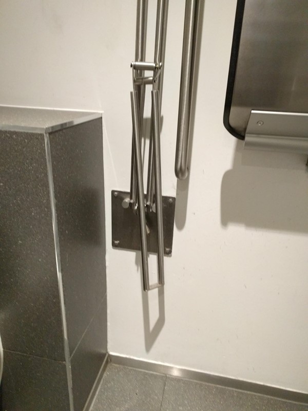 Broken grab-rail in the accessible toilet