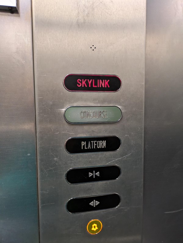 Image of buttons in the left, the buttons are marked SKYLINK, CONCOURSE and PLATFORM. There are also a close door, open door and alarm button.
