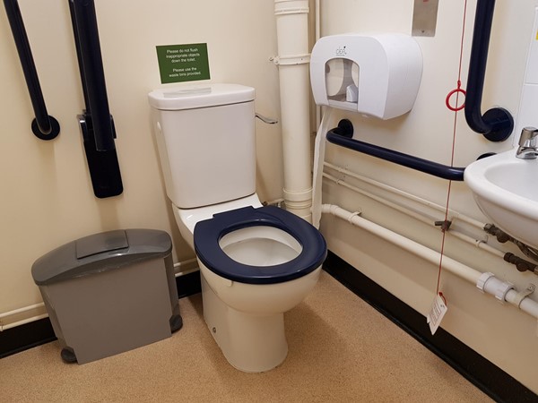 The loo where someone before me had left a Euan's Guide emergency cord card!