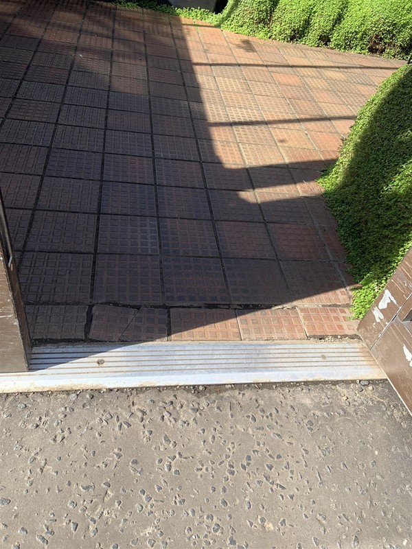 Image of a slightly raised metal threshold inside the greenhouse