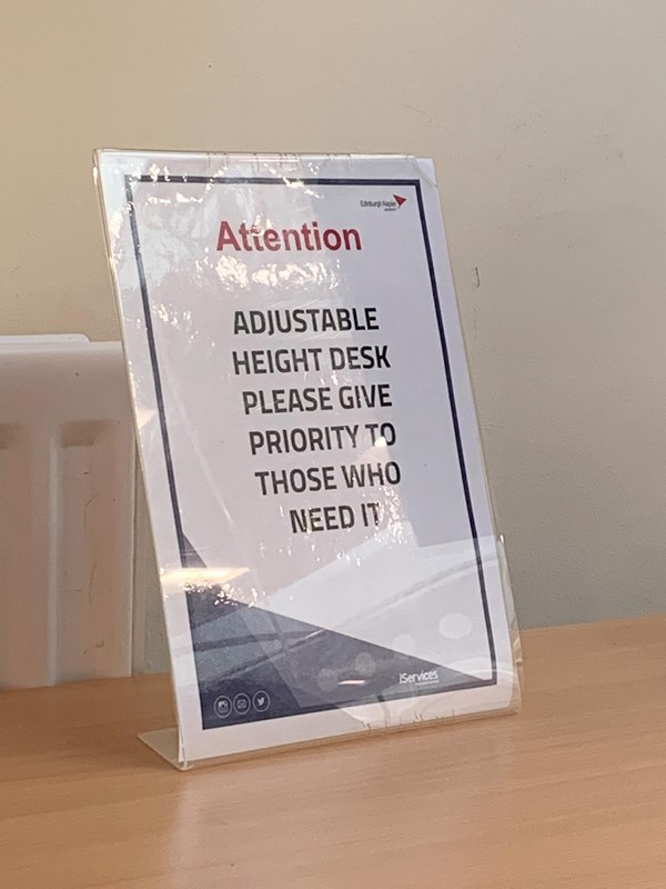 Sign for adjustable desk