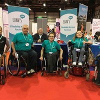 Image of Claire and other Ambassadors at an exhibition stall spreading awareness of Euan's Guide.